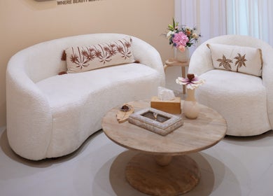 Stylish lounge area at Reed Women Beauty And Fitness Center, Abu Dhabi, AE with soft couches and elegant decor.