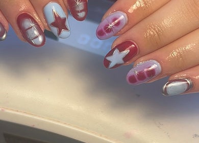 Star-themed nail art design at NailsbyMichaela in Plymouth, England, GB showcasing red and blue colors.