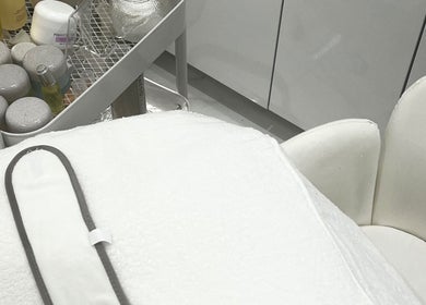 Luxurious skincare products at Sacred Skin and Wellness, Kingsteignton, England, GB setup for a relaxing treatment.
