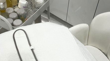 Luxurious skincare products at Sacred Skin and Wellness, Kingsteignton, England, GB setup for a relaxing treatment.