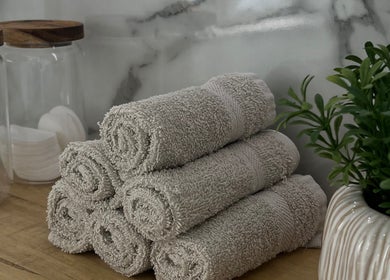 Rolled towels and greenery at Sacred Skin and Wellness in Kingsteignton, England, GB, enhancing relaxation.