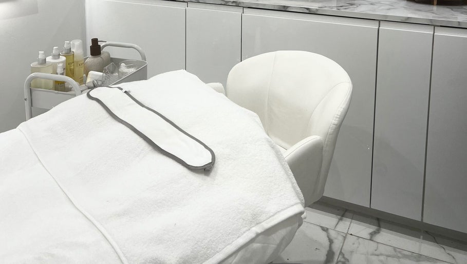 Serene treatment room at Sacred Skin and Wellness in Kingsteignton, England, GB with modern decor.