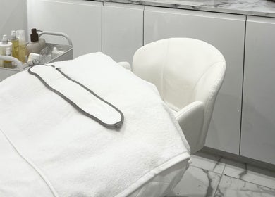 Serene treatment room at Sacred Skin and Wellness in Kingsteignton, England, GB with modern decor.