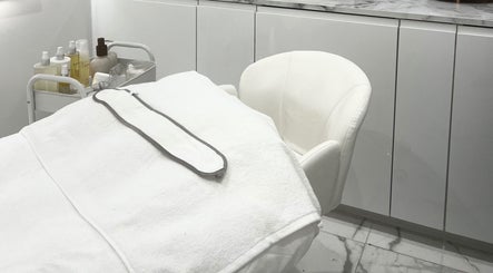 Serene treatment room at Sacred Skin and Wellness in Kingsteignton, England, GB with modern decor.