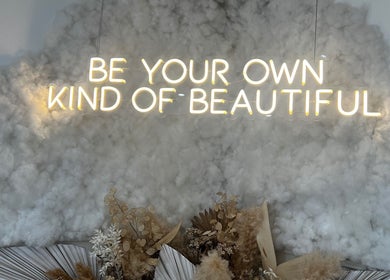 Neon sign 'Be Your Own Kind of Beautiful' at Sacred Skin and Wellness, Kingsteignton, England, GB.