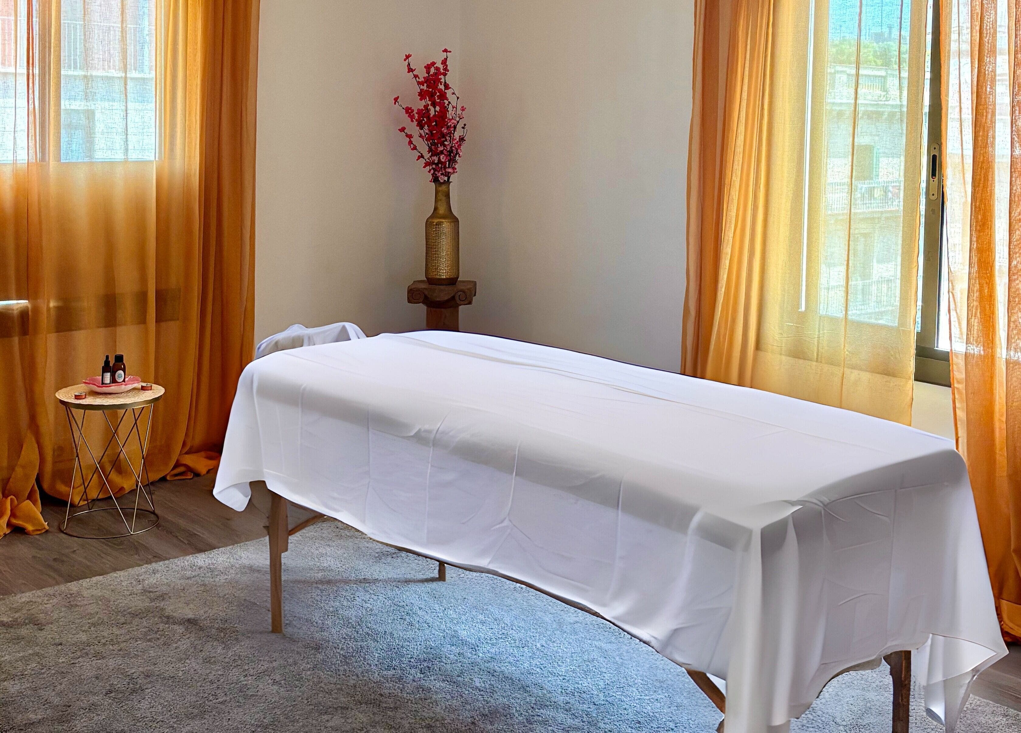 Tranquil massage room at Heaven Massage Barcelona with table, decor, and soft lighting in Barcelona, Catalunya, ES.