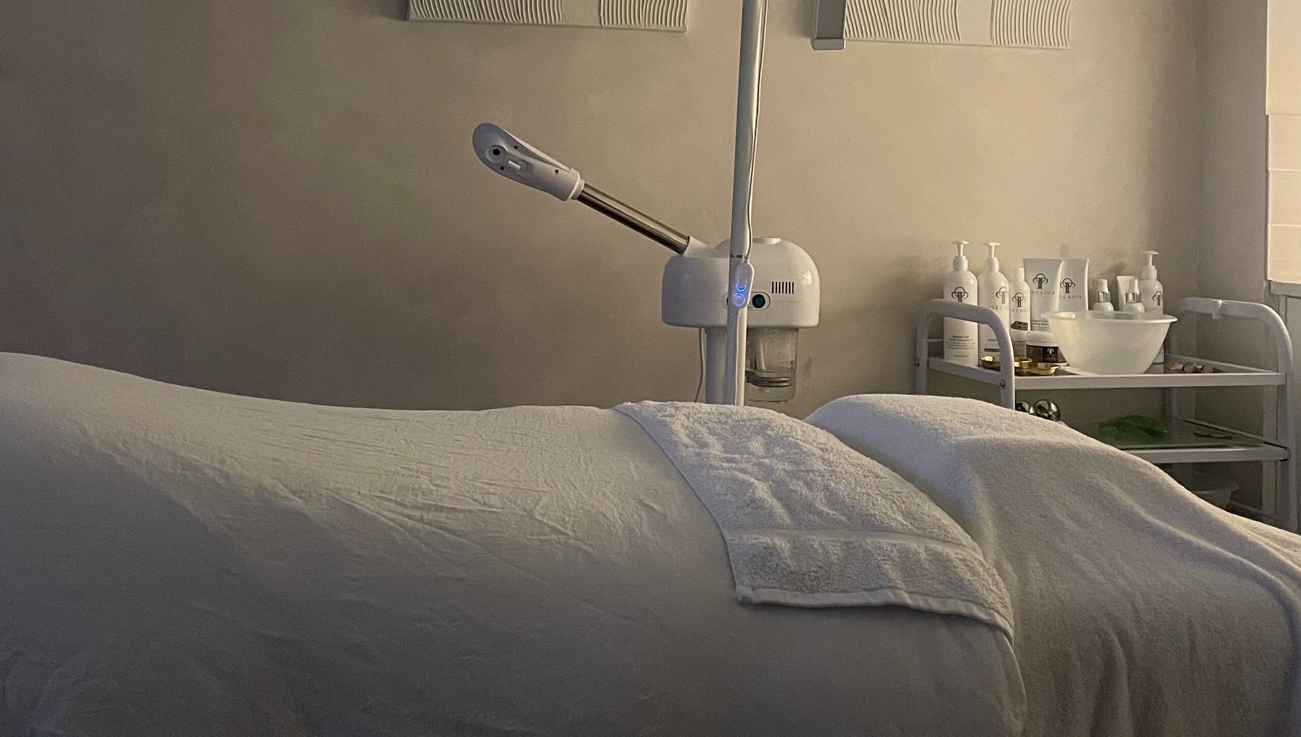 Relaxing treatment room at The Skin Studio Cirencester, Cirencester, England, GB, featuring a cozy massage table.