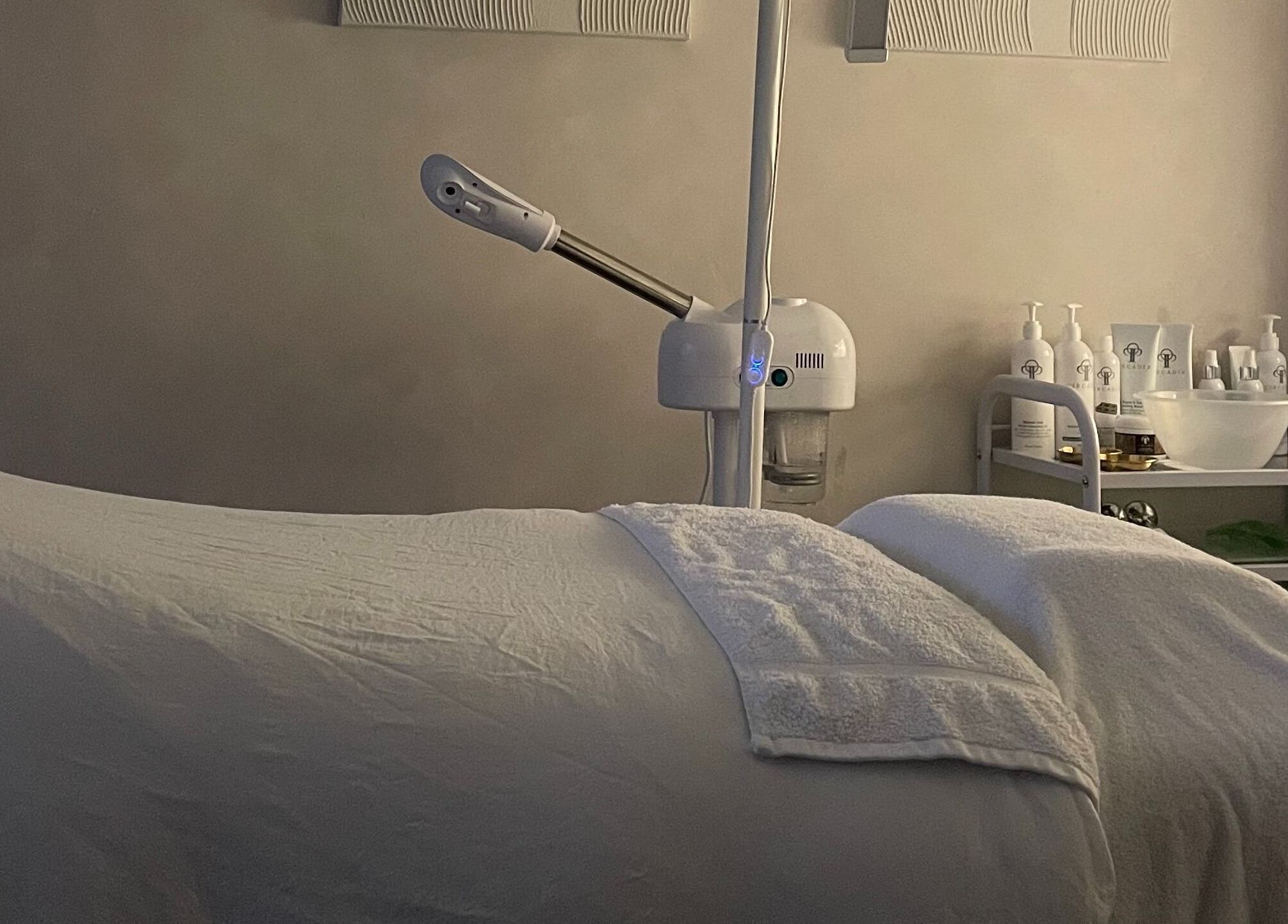 Relaxing treatment room at The Skin Studio Cirencester, Cirencester, England, GB, featuring a cozy massage table.