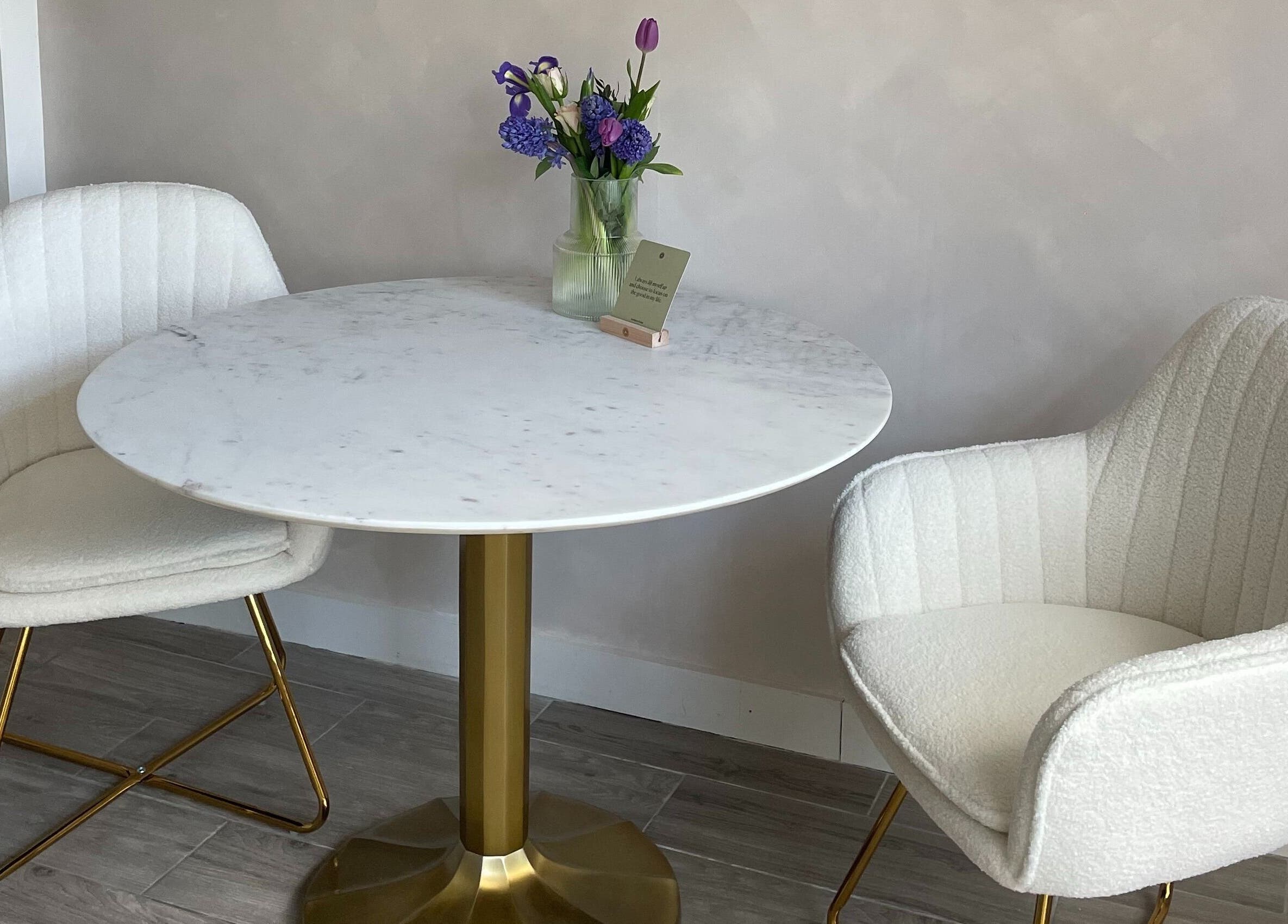 Elegant seating area at The Skin Studio Cirencester, Cirencester, England, GB with a marble table and plush chairs.