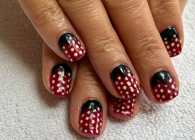 Strawberry nail design at Aura Nails, Great Oxendon. Trendy nail art with fruit theme.
