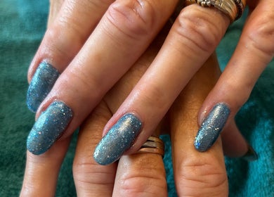 Glittery blue nails at Aura Nails, Great Oxendon, England, enhancing elegance and style.
