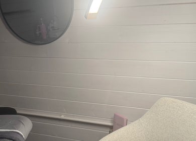 Peaceful massage room at The Glow Room by Han, Burscough, England, GB, featuring warm lighting and a cozy chair.