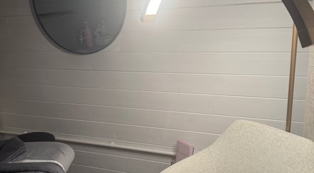 Peaceful massage room at The Glow Room by Han, Burscough, England, GB, featuring warm lighting and a cozy chair.