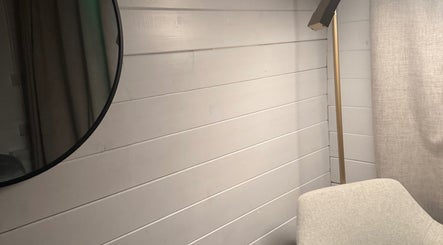 Elegant corner with mirror and chair at The Glow Room by Han, Burscough, England, GB.