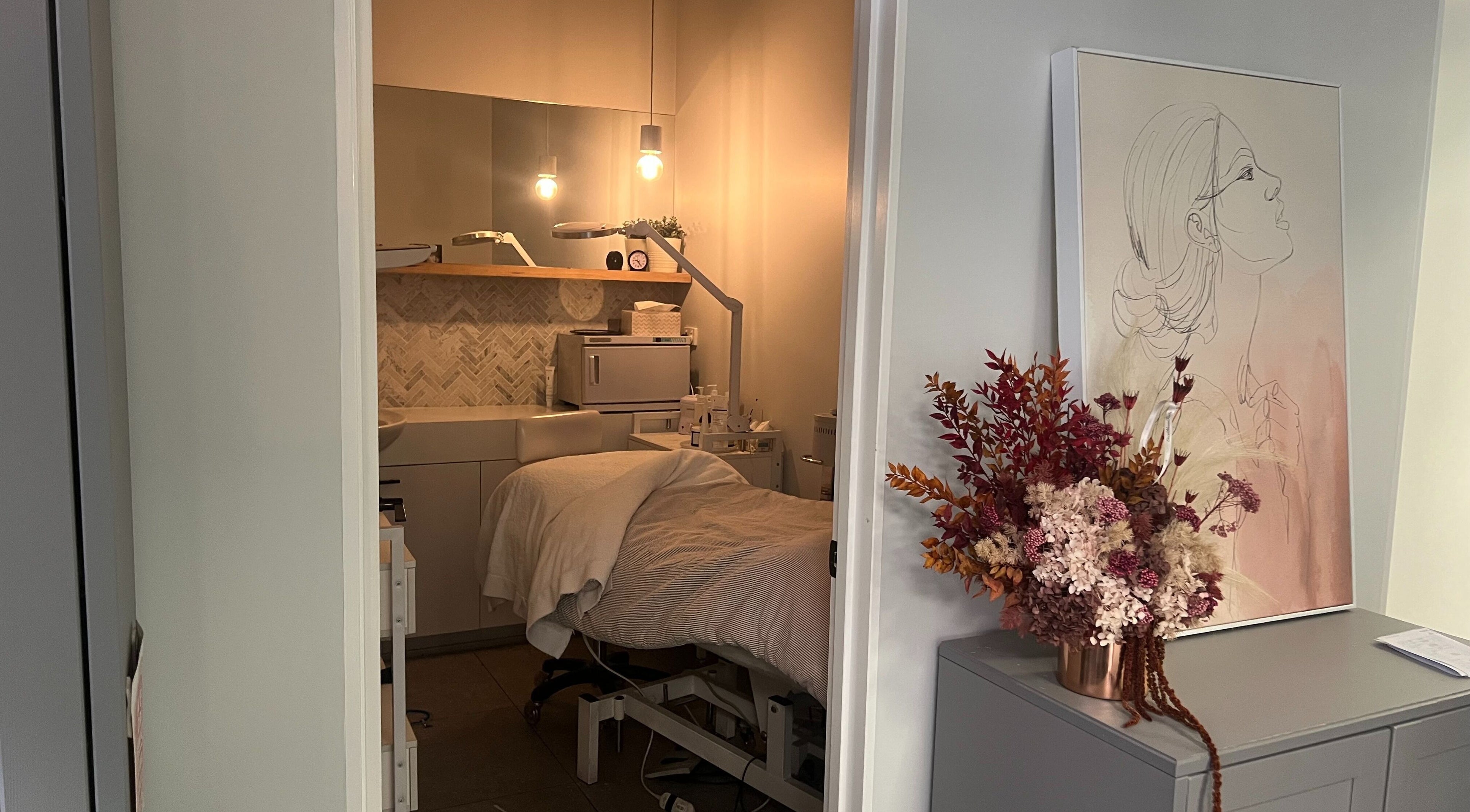 Cozy treatment room at Sabi Skin & Beauty in Melbourne, Victoria, AU, featuring a comfortable bed and soft lighting.