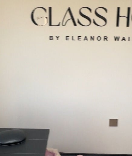 Interior of Byhollycampbell in Rotherham, England with stylish decor and Glass House branding on wall.