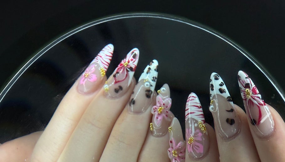 Intricate floral nail art at Nailsbyaimz, Kempston, England, GB, showcasing delicate pink and gold designs.