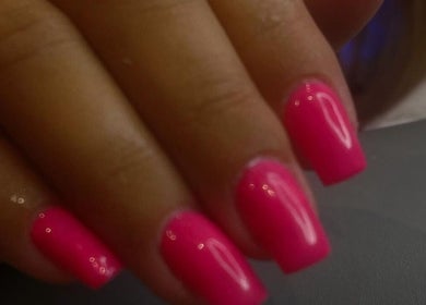 Bright pink manicured nails at Nailsbyaimz, Kempston, England, GB.