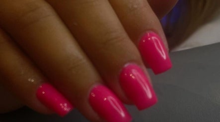 Bright pink manicured nails at Nailsbyaimz, Kempston, England, GB.