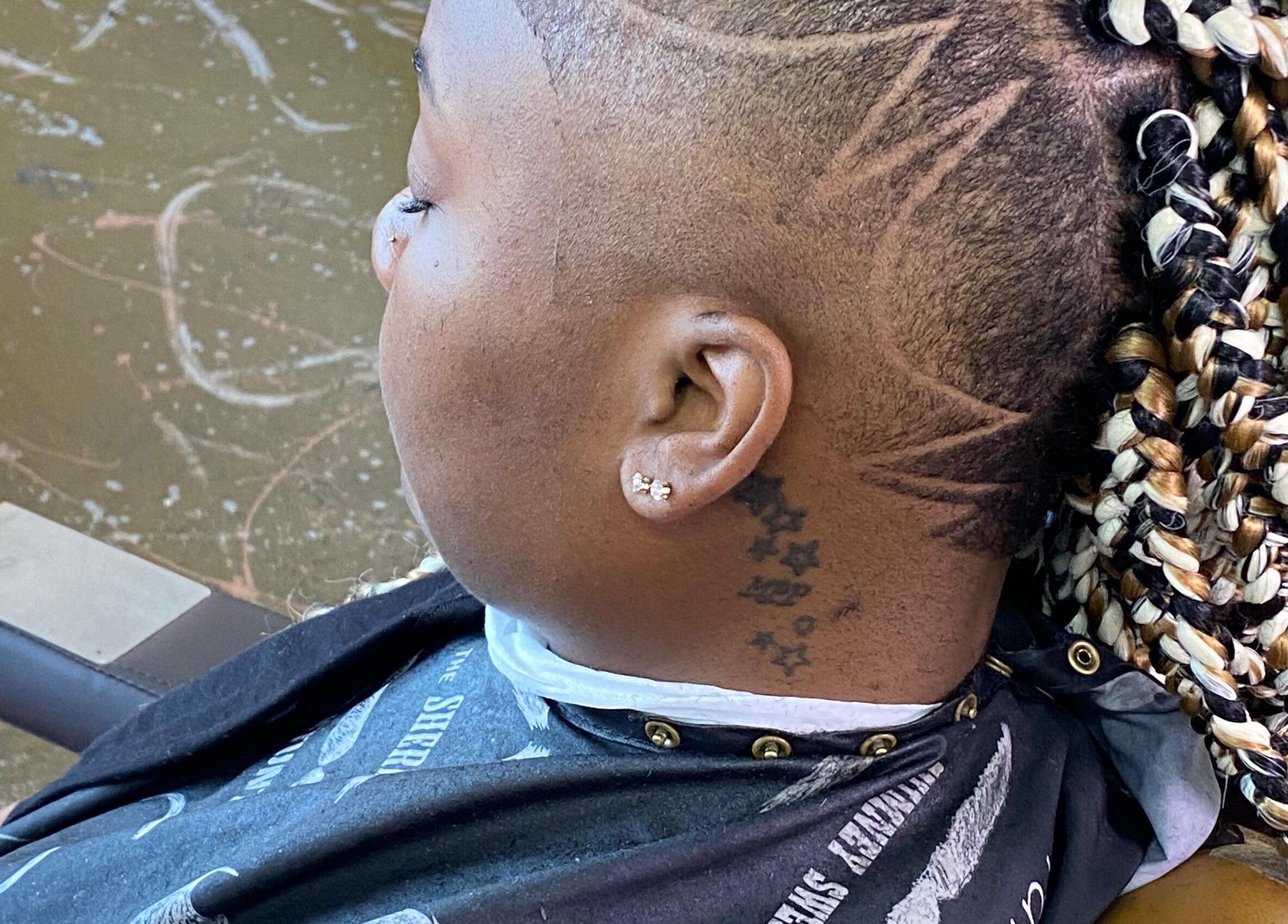Intricate braid design and shaved pattern at Dedicated cuts and styles, Marrero, Louisiana, US.