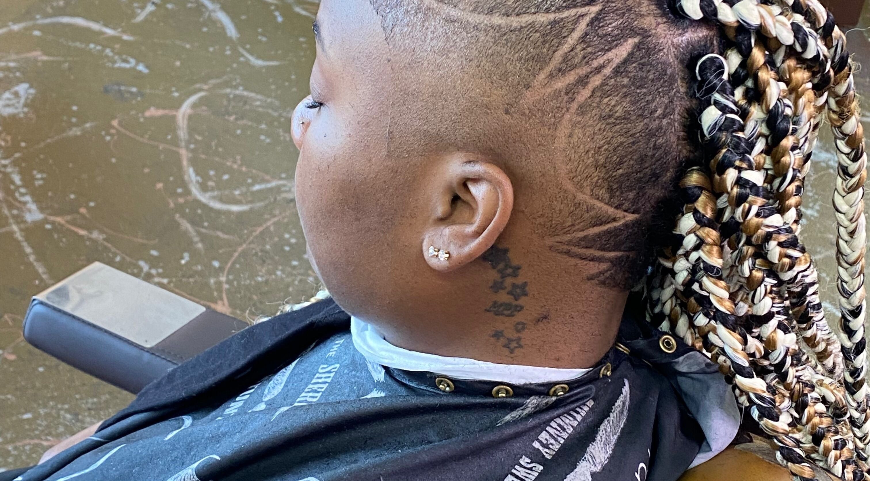 Intricate braid design and shaved pattern at Dedicated cuts and styles, Marrero, Louisiana, US.