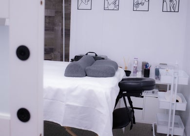 Massage room at Calm And Cozy Spa in Long Branch, New Jersey, US, featuring a comfortable treatment bed.