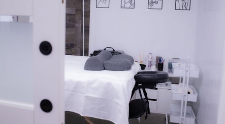 Massage room at Calm And Cozy Spa in Long Branch, New Jersey, US, featuring a comfortable treatment bed.