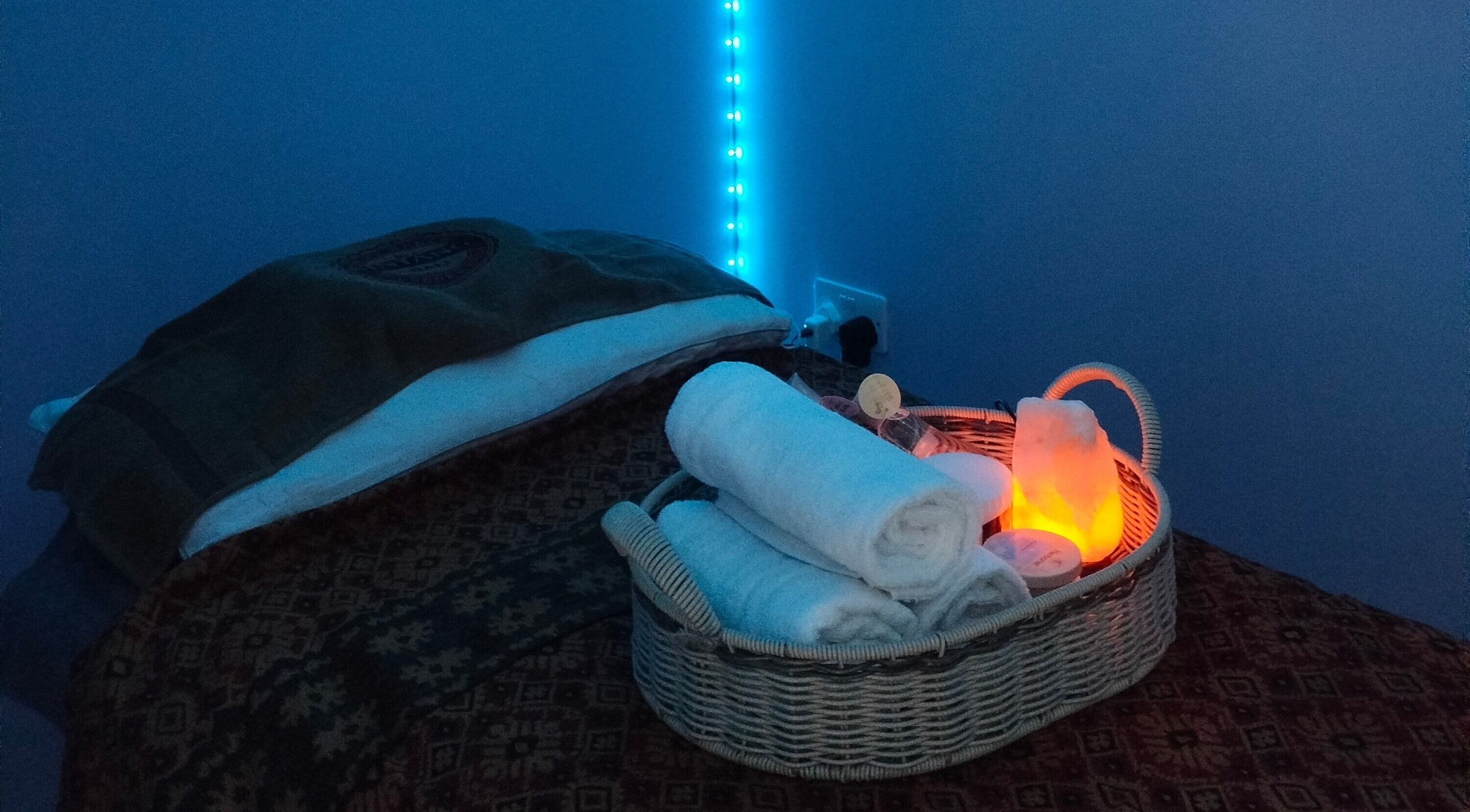 Tranquil massage room at Bali By Dee - Beauty Treatments in Colchester, England, GB, with glowing ambient light.