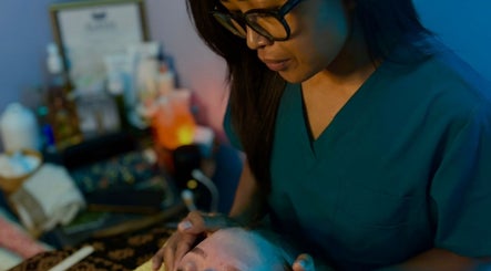 Therapist performing a relaxing facial at Bali By Dee - Beauty Treatments, Colchester, England, GB.