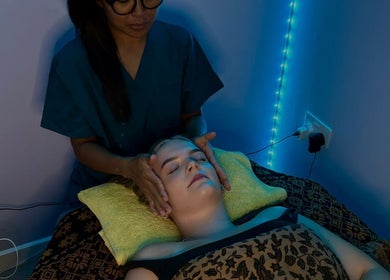 Relaxing face massage at Bali By Dee - Beauty Treatments in Colchester, England, GB under soft ambient lighting.