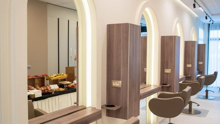 Modern salon interijer u Aria, Vitez, Federacija Bosne I Hercegovine, BA, s elegantnim ogledalima i stolcima.