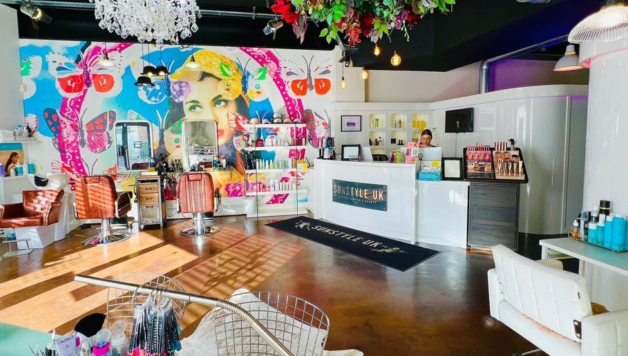 Inside Jessica Arwand Aesthetics, Cobham, England, GB with colorful mural and salon chairs.