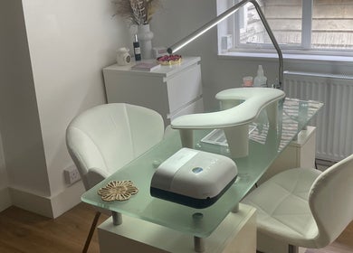 Elegant nail station at Viennas beauty, Sevenoaks, England, GB, with modern white decor and comfortable seating.