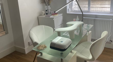 Elegant nail station at Viennas beauty, Sevenoaks, England, GB, with modern white decor and comfortable seating.