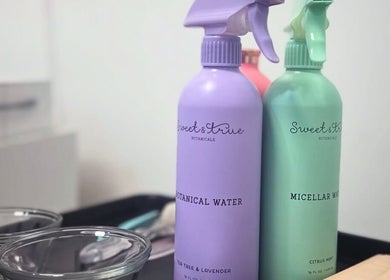 Botanical skincare bottles at Jo Lutayi Esthetician in London, England for natural beauty treatments.