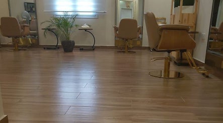 Modern interior of Alzaina salon in Umm Salal Muhammed, featuring sleek chairs and wooden flooring.