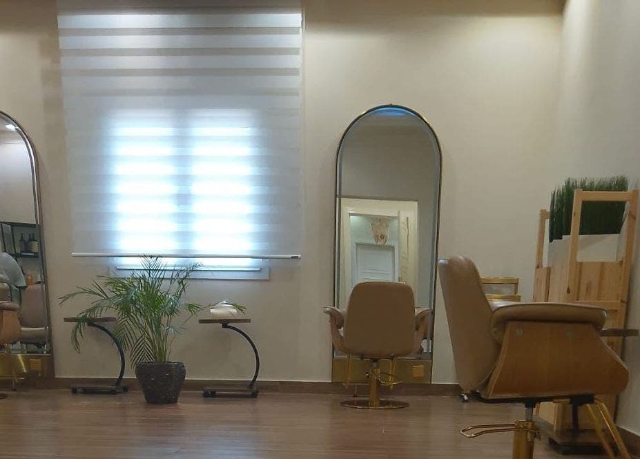 Sophisticated interior of Alzaina Salon in Umm Salal Muhammed, featuring styling chairs and mirrors.