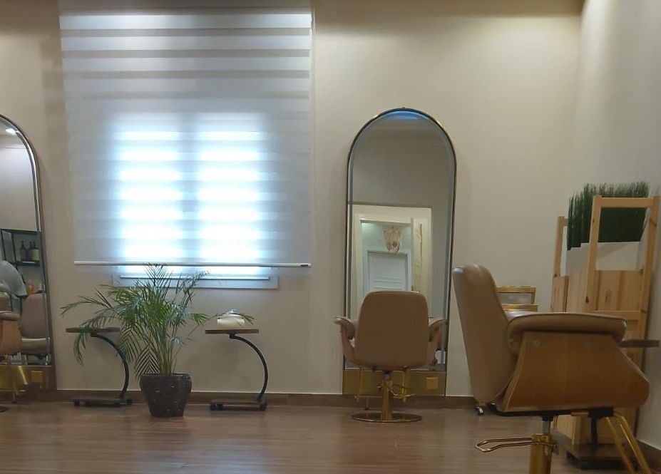 Sophisticated interior of Alzaina Salon in Umm Salal Muhammed, featuring styling chairs and mirrors.
