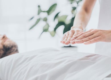 Reiki healing session at La Rosa Blanca | Reiki & Yoga in Glasgow, Scotland, GB. Hands hovering over client.