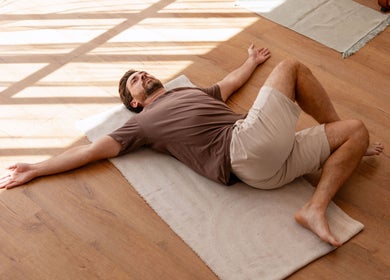 A man practices yoga in sunlight at La Rosa Blanca | Reiki & Yoga, Glasgow, Scotland, GB.