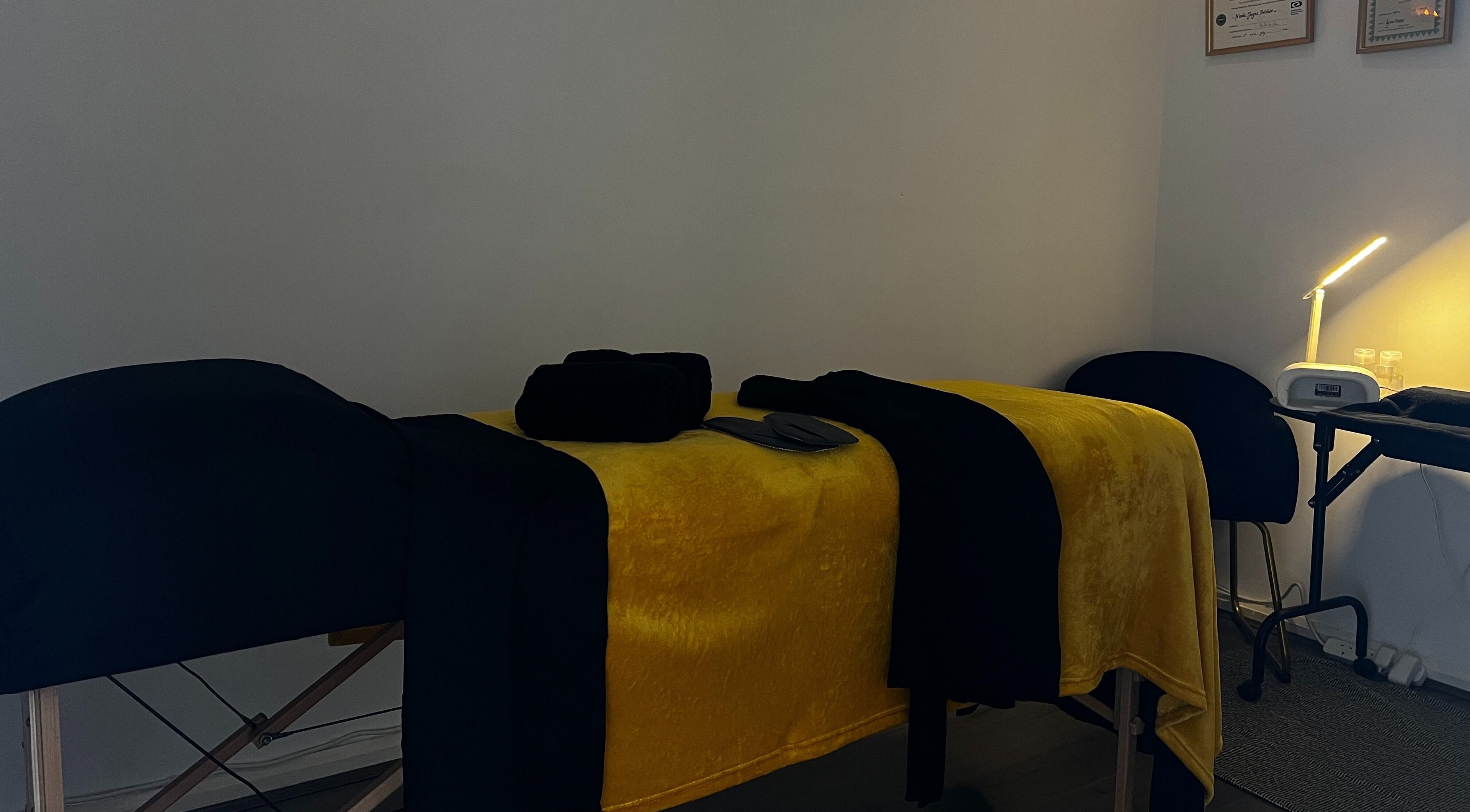 Tranquil massage room at Beauty In Simplicity, Warrington, England, GB, with a neatly set massage bed.