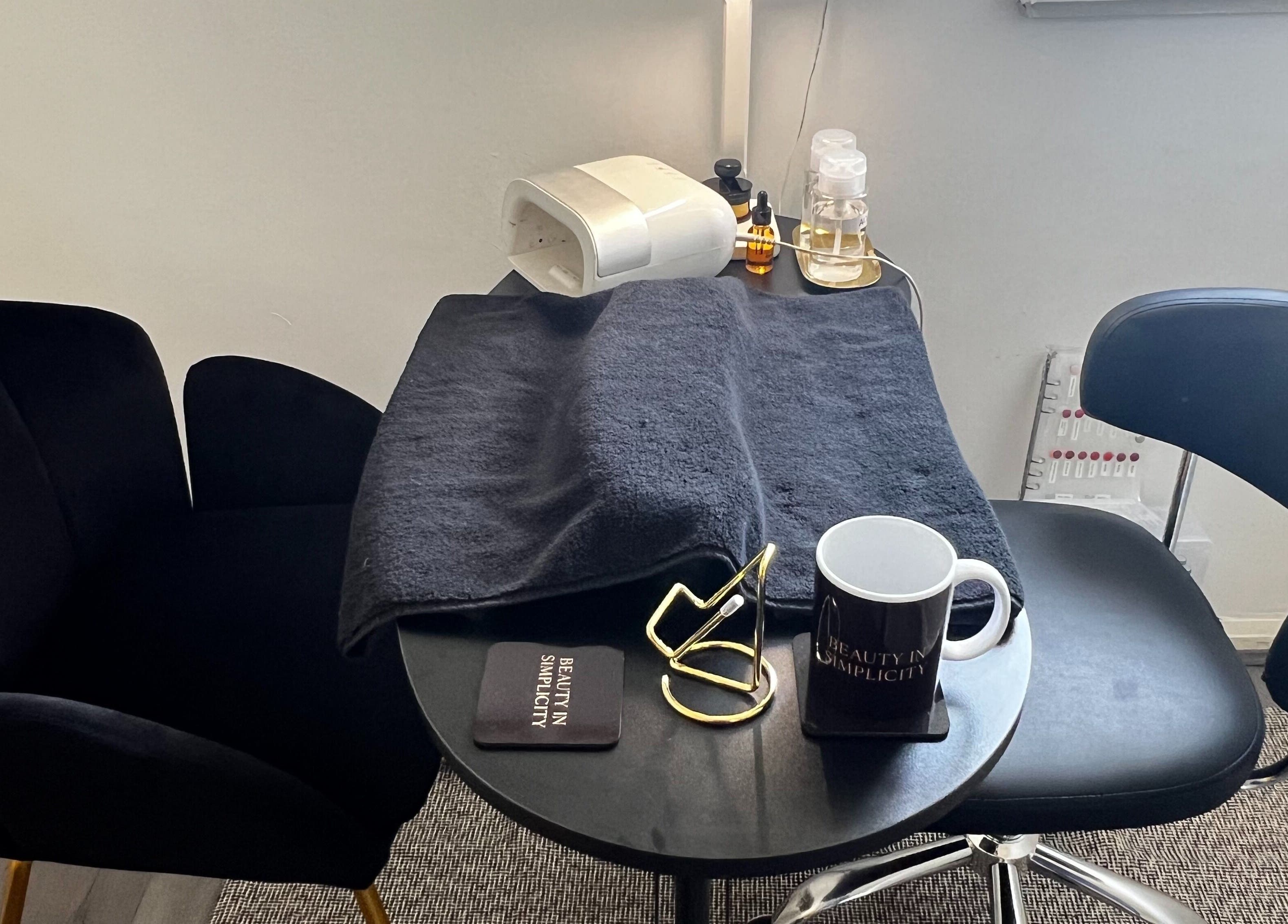 Elegant nail station at Beauty In Simplicity, Warrington, England, GB with plush seating and manicure tools.