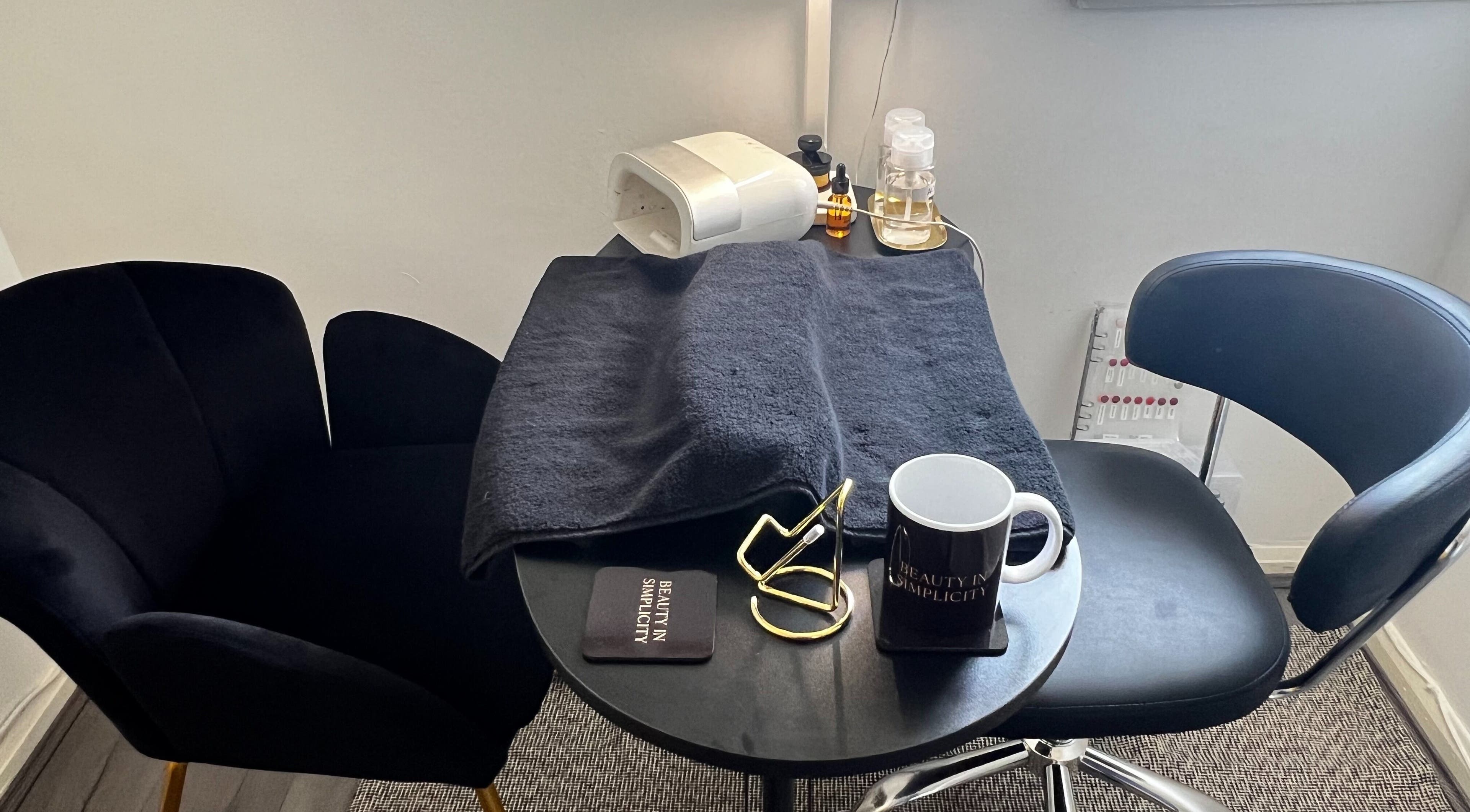 Elegant nail station at Beauty In Simplicity, Warrington, England, GB with plush seating and manicure tools.