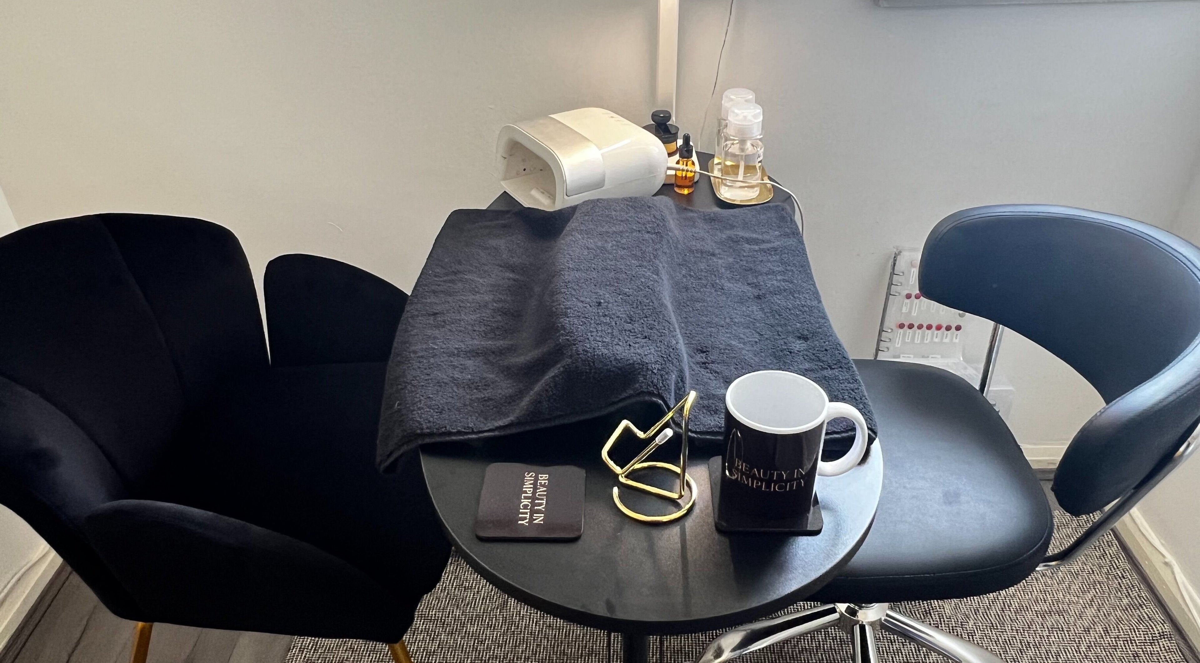 Elegant nail station at Beauty In Simplicity, Warrington, England, GB with plush seating and manicure tools.