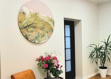 Elegant interior of Estētiskais pedikīrs in Liepāja, LV with vibrant floral decor and modern artwork.