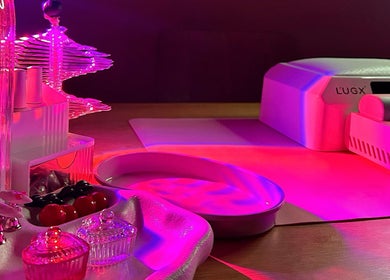 Luxurious nail setup at Nails Gelato, Melbourne, Victoria, AU, with pink lighting and modern decor.