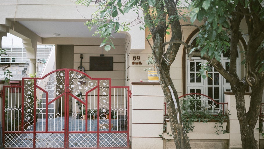 Welcoming front gate of Solo Music Lessons, Bengaluru, Karnataka, IN, surrounded by greenery.