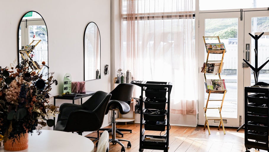 Inside view of Amy salon in Porirua, Wellington Region, NZ, showcasing cozy chairs and stylish decor.