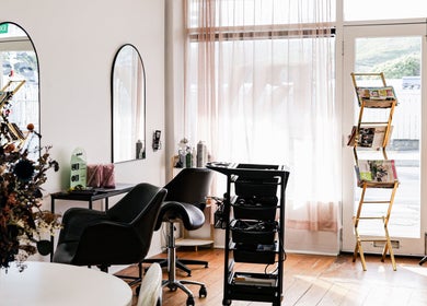 Inside view of Amy salon in Porirua, Wellington Region, NZ, showcasing cozy chairs and stylish decor.