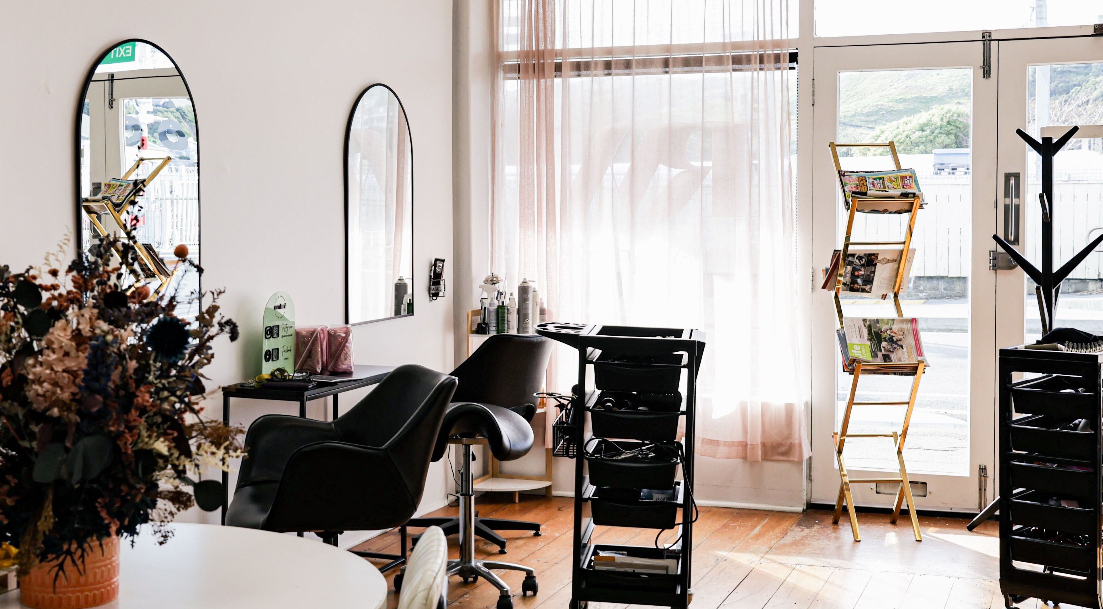 Inside view of Amy salon in Porirua, Wellington Region, NZ, showcasing cozy chairs and stylish decor.